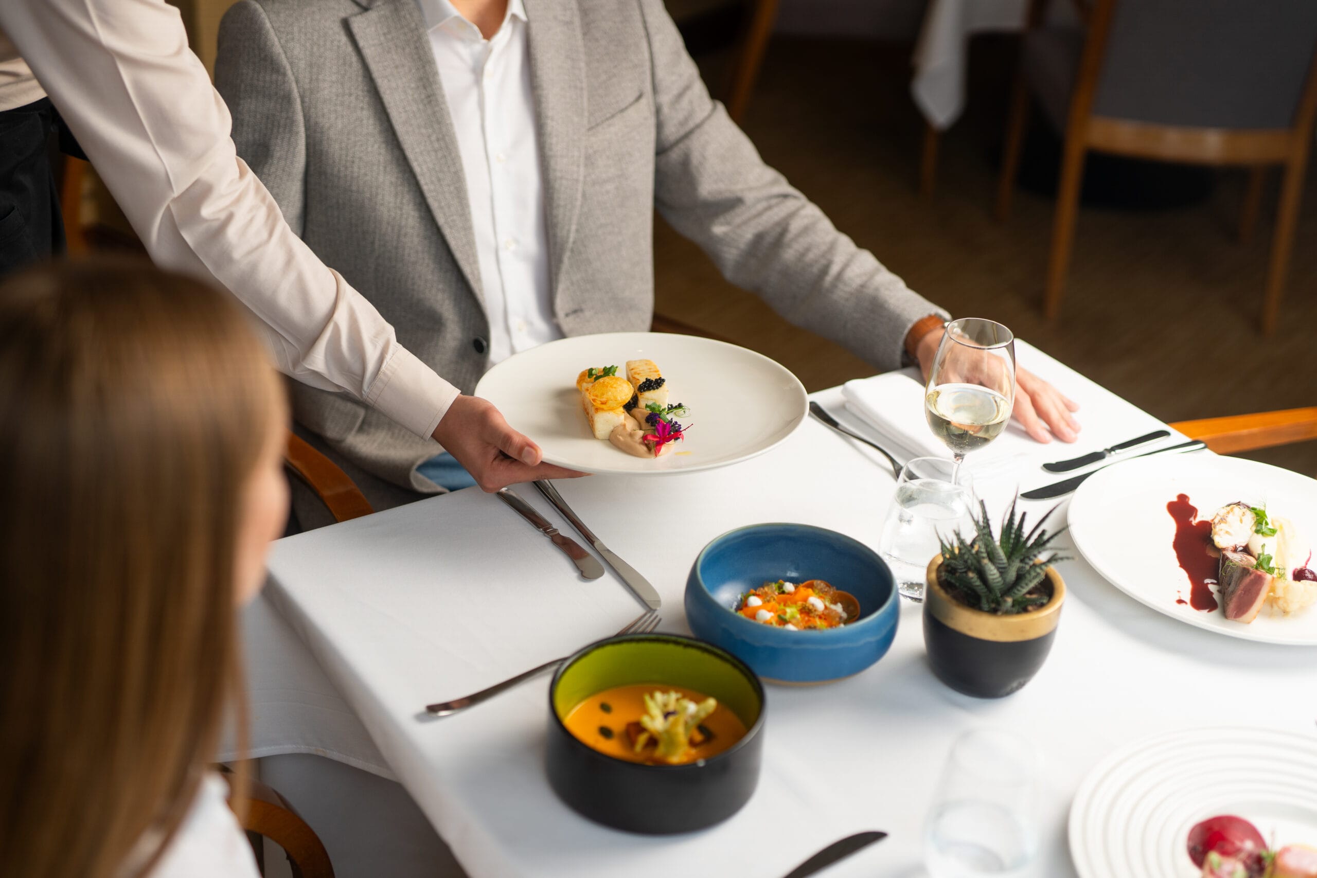 Plated dishes served at a restaurant table — food photography for a hospitality client