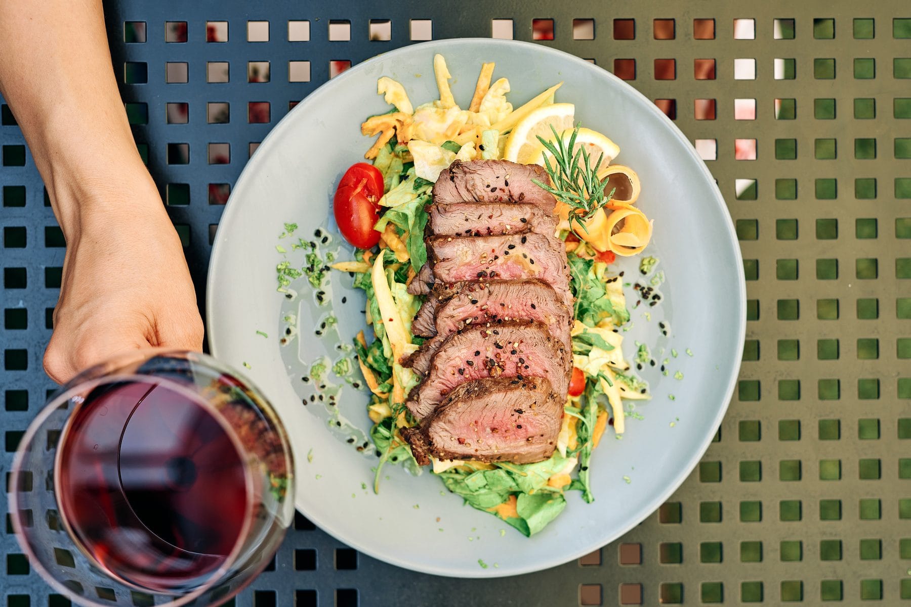 Sliced steak with salad on a restaurant table, photographed on location